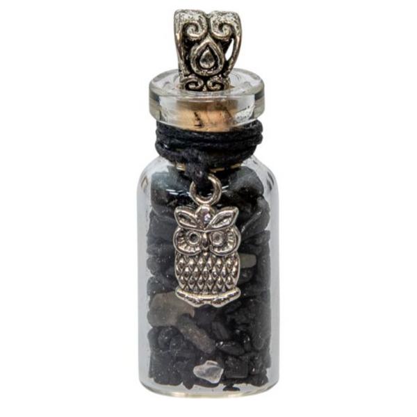 Miniature glass bottle pendant filled with black tourmaline chips, adorned with an owl charm, symbolizing protection and wisdom.