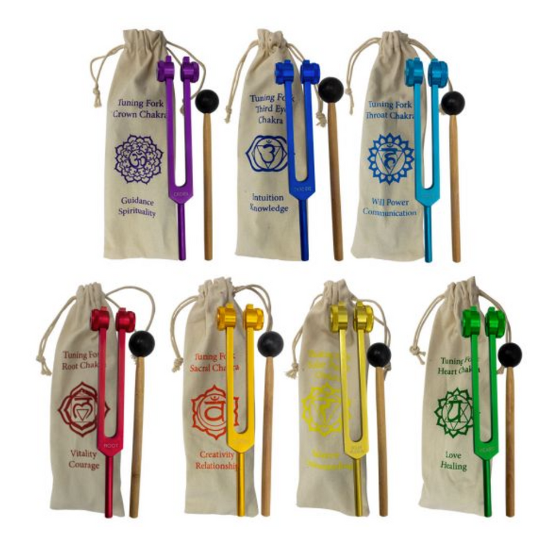 Set of seven color-coded chakra tuning forks with bags