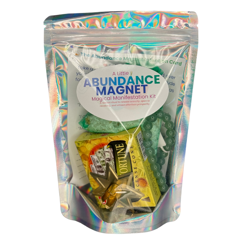 Abundance Magnet Kit with green candle, Palo Santo, Pyrite nugget, Green Aventurine crystal, and bracelet on a white background.