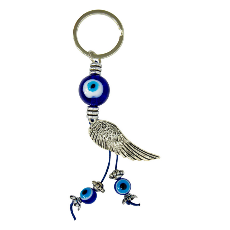 Keychain with blue evil eye charms and a silver wing on a white. Angel Wing Evil Eye Glass Talisman with blue glass Evil Eye and silver angel wing accents, used for protection and spiritual décor.background