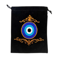 Embroidered velvet bag with evil eye design