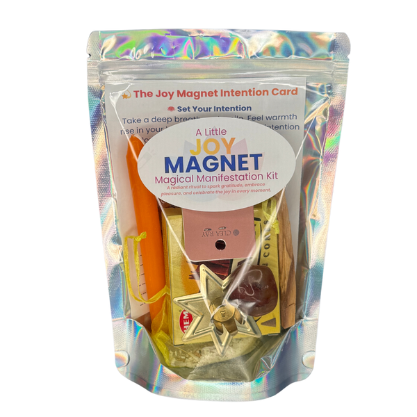 Joy Magnet Kit with orange candle, Palo Santo, Carnelian stone, and matching bracelet on a white background.