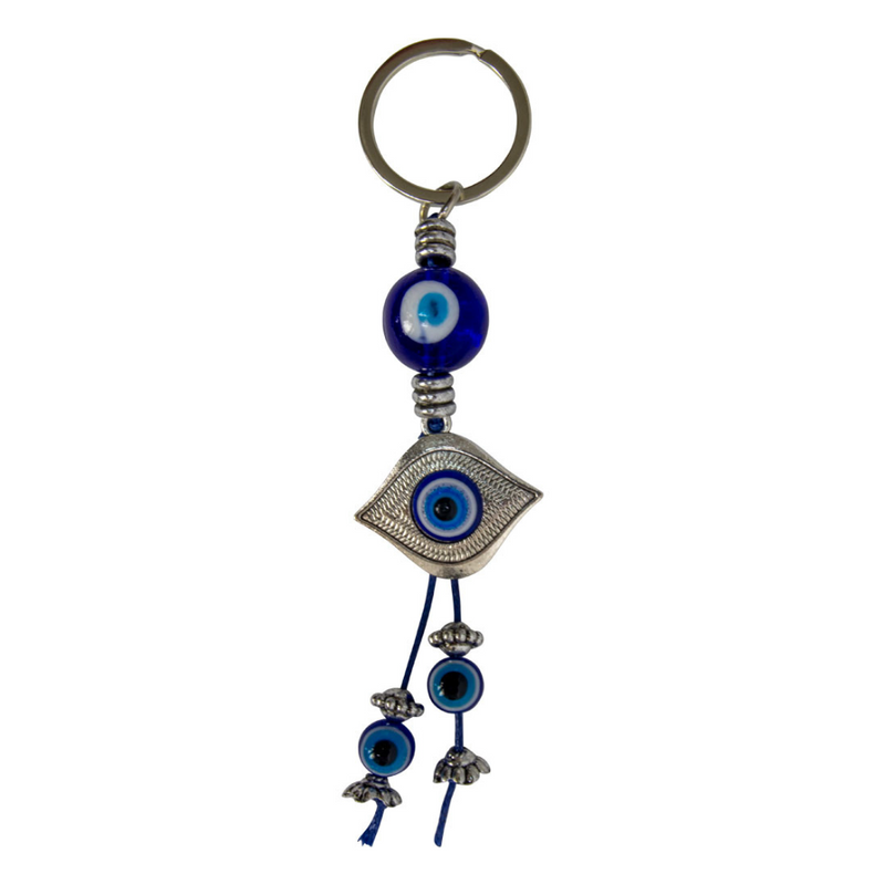 Keychain with blue evil eye beads on a white background. Metal Evil Eye Glass Talisman with blue glass design framed in metal, used for protection and spiritual décor.