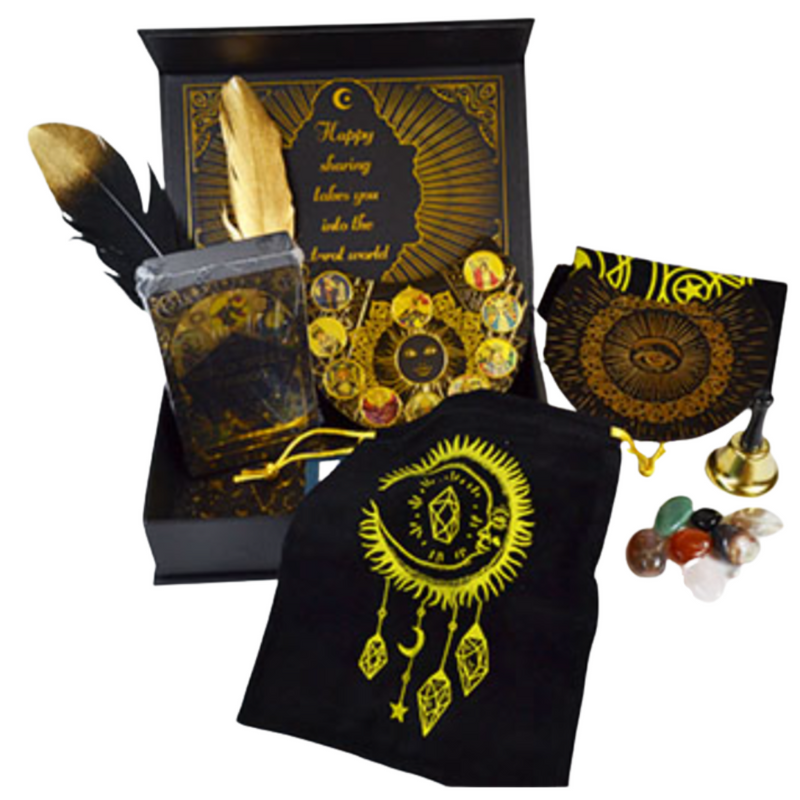 Decorative set with black and gold items including a feather, crystal pouch, and amulets on a white background.
