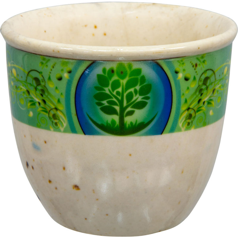 A small beige ceramic smudge pot with a green and blue floral pattern featuring a Tree of Life design.